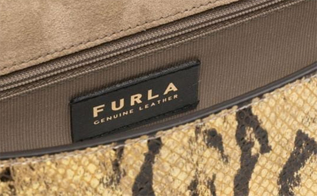Gros plan sur l etiquette Furla qui est a l interieur du sac.